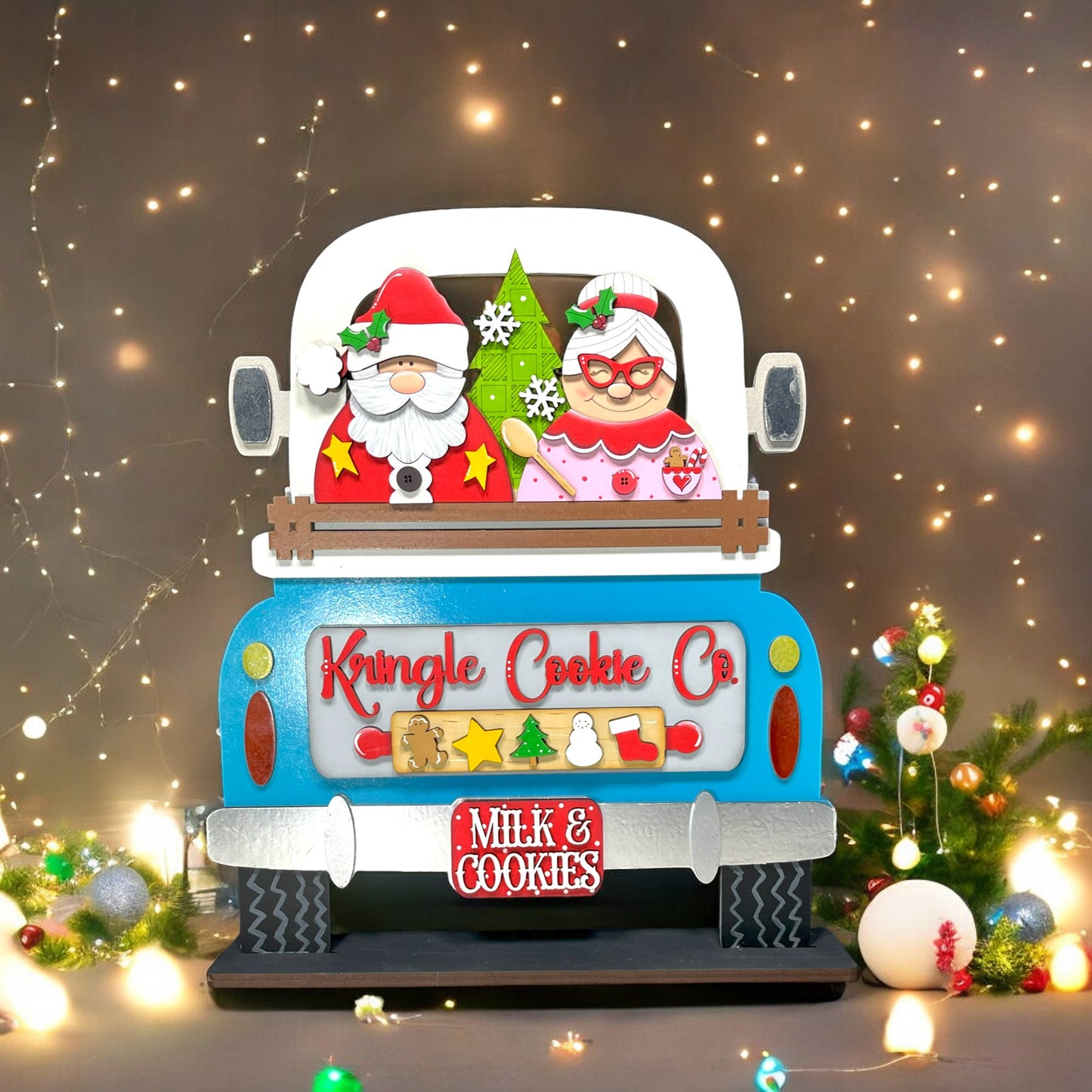 a blue truck with a santa clause on the back of it