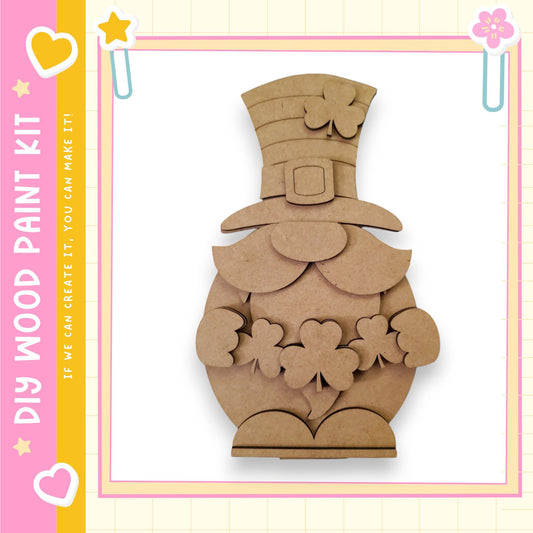 A cardboard cutout of a smiling, cartoon-like character wearing a hat with four clovers, set against a pink and yellow background.