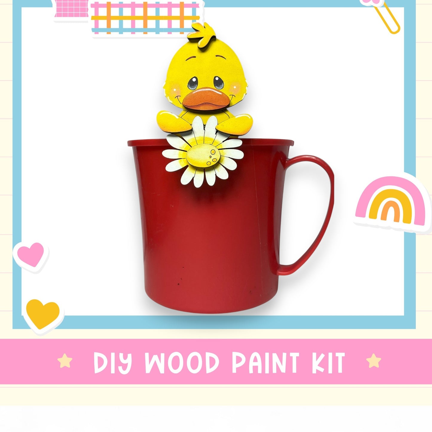 A red mug with a yellow duck figurine holding a white flower, surrounded by various colorful stickers and hearts, with the text "DIY WOOD PAINT KIT" below.