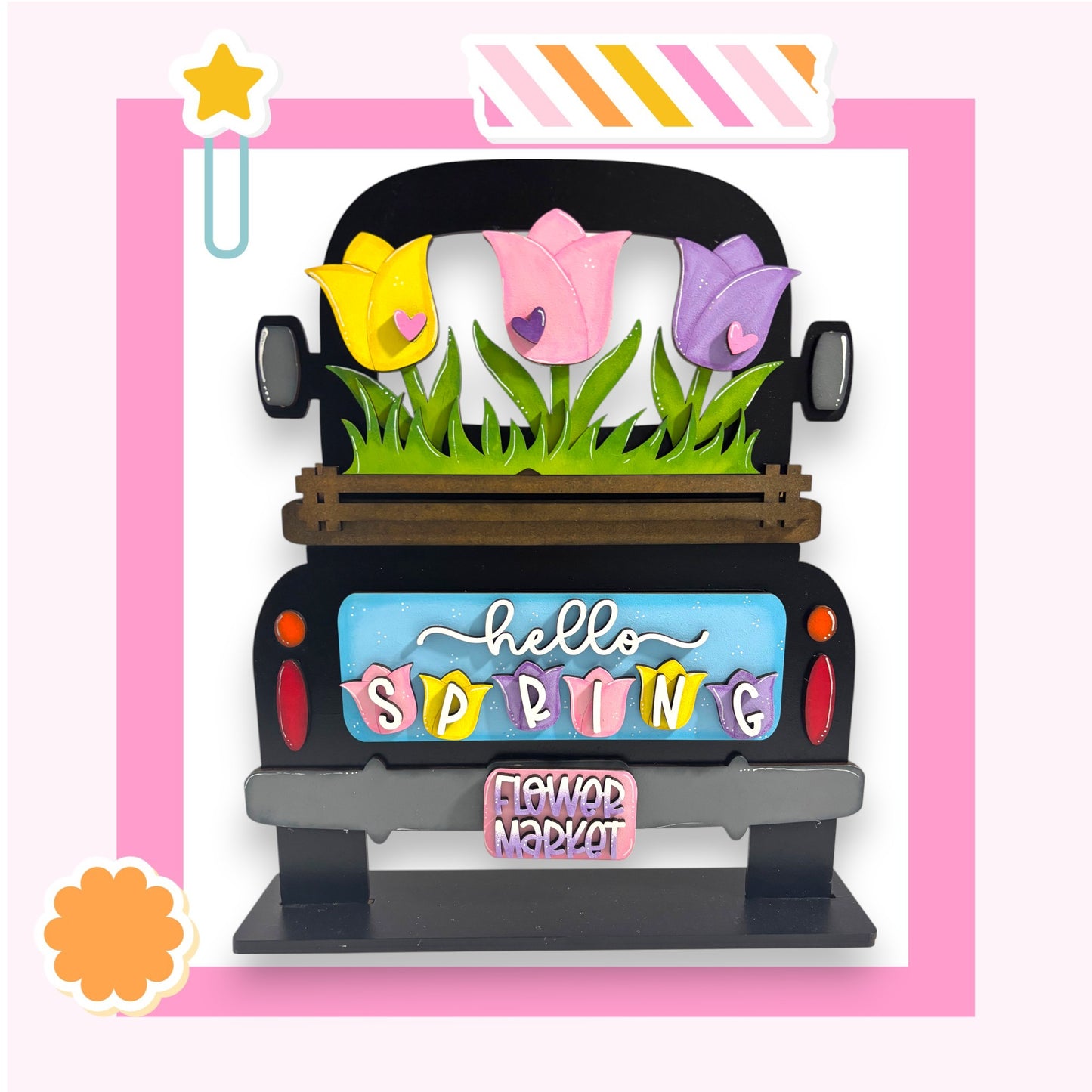 A colorful and whimsical truck decoration with a floral design and the text "Hello Spring" displayed on the back.
