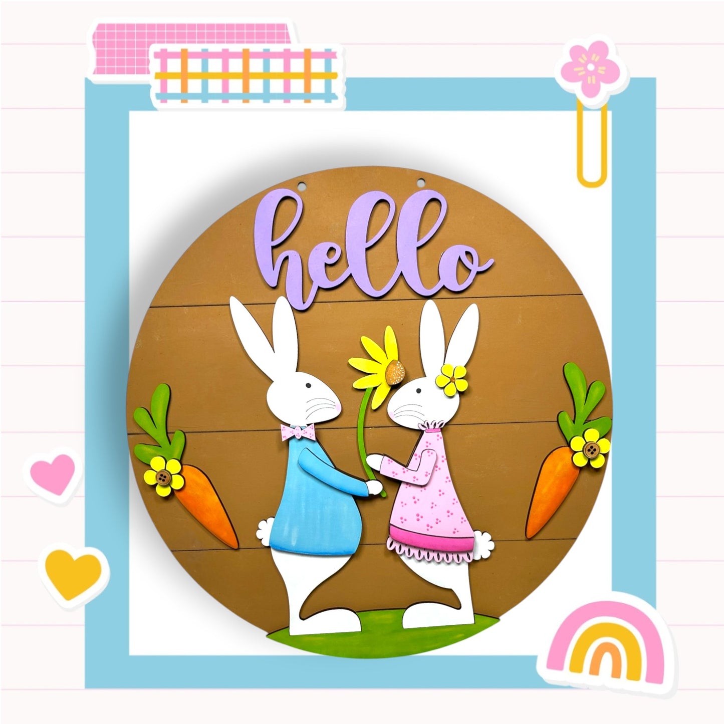 a picture of a couple of rabbits holding carrots