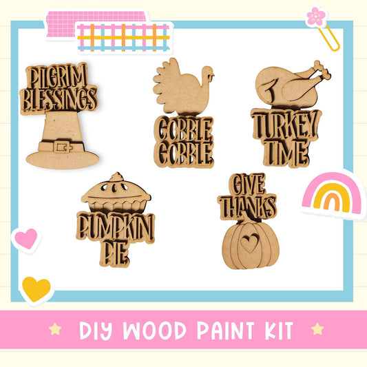 a DIY wood paint kit for creating Thanksgiving-themed decorations, including a turkey, a pumpkin pie, and other festive elements.