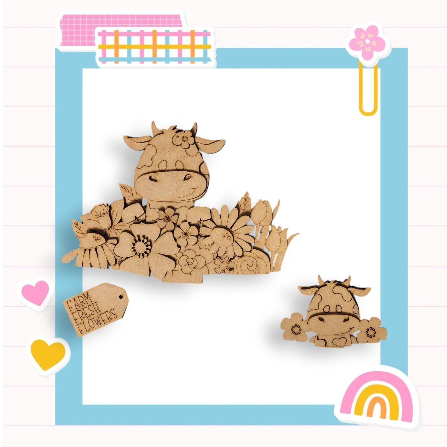 a wooden cutout of a cow sitting on a bed of flowers