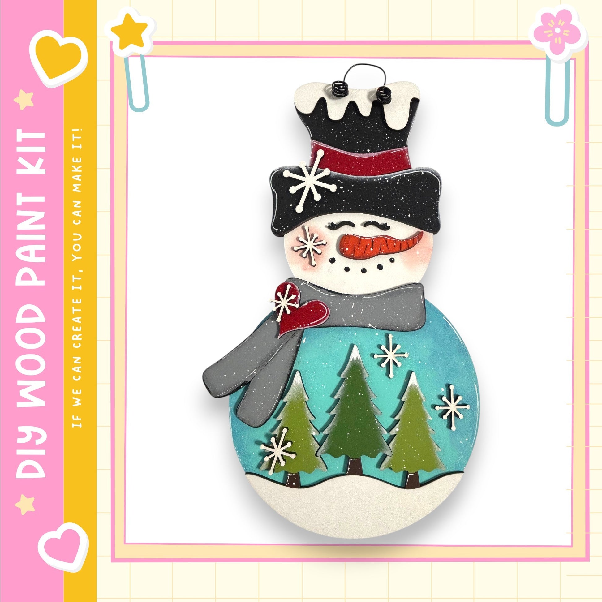 A snowman made of wood, with a blue base, green trees, and a red scarf, is displayed against a white background.