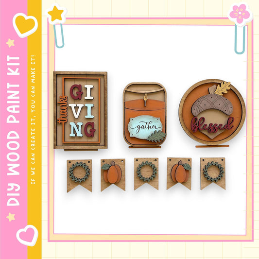 various wooden decorations and signs related to the Thanksgiving holiday, including a "Gift Giving" sign, a "Gather" sign, and a "Blessed" sign. The decorations are arranged in a row, creating a festive display.