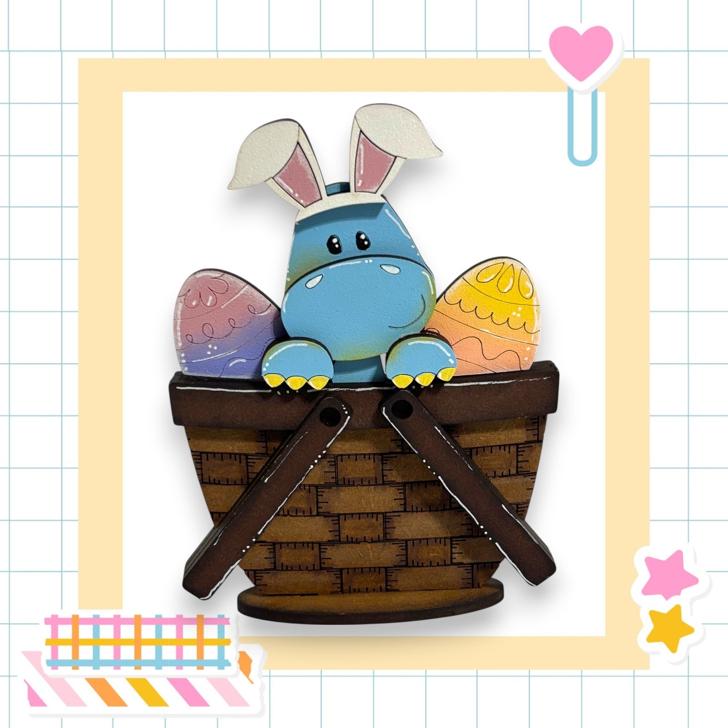 A blue Easter bunny with white ears and a brown basket sits in a basket, surrounded by colorful Easter eggs.