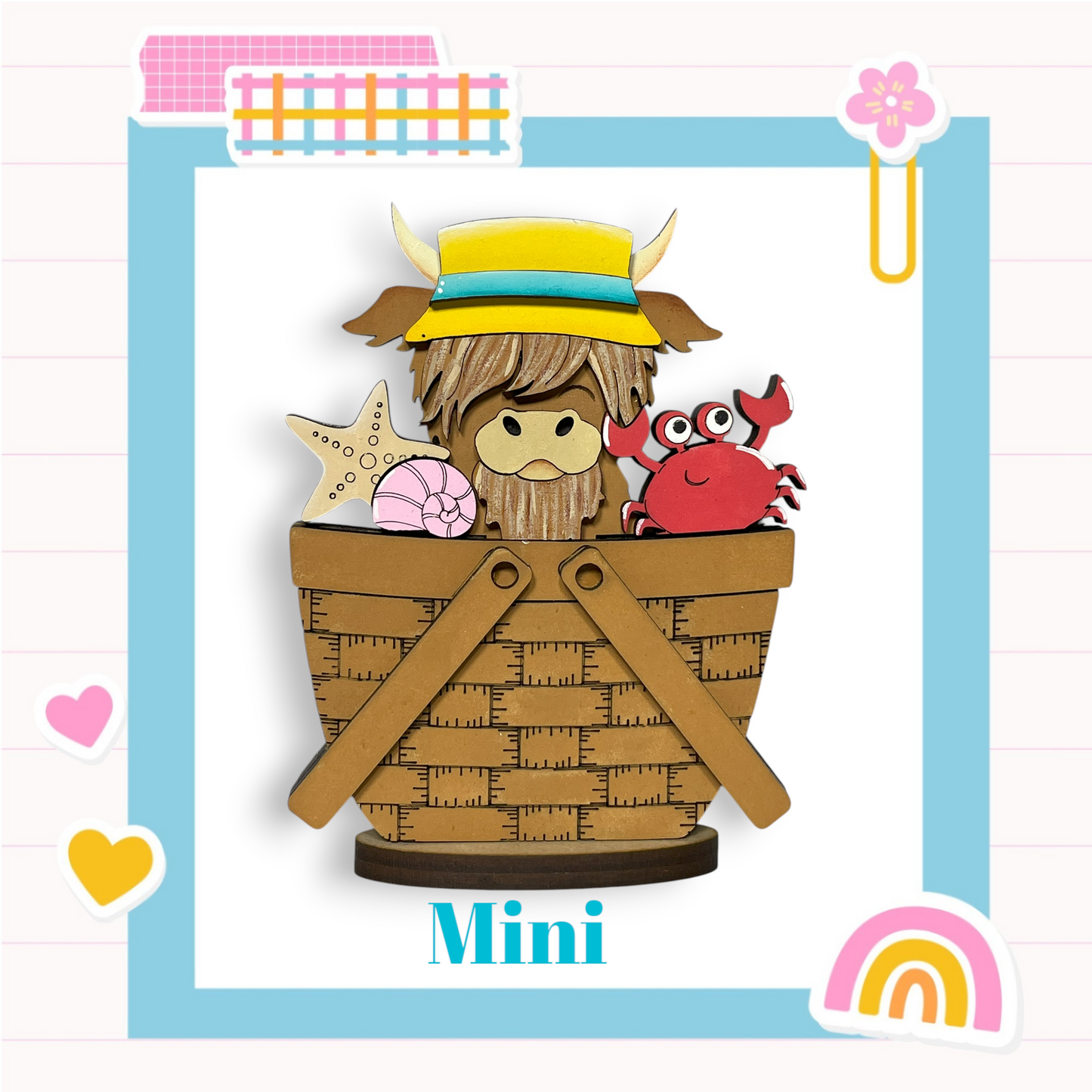A wooden basket with a cow wearing a hat and holding a starfish and a crab.