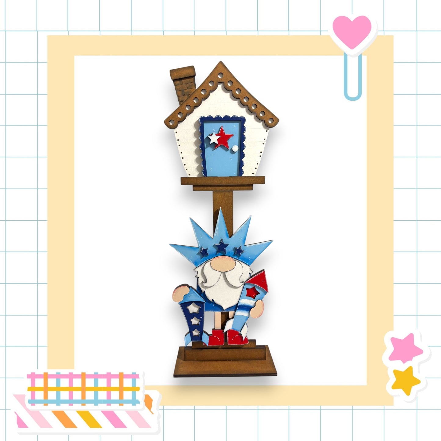 A wooden birdhouse with a gnome figure sitting on top, surrounded by colorful stickers and a heart-shaped object.