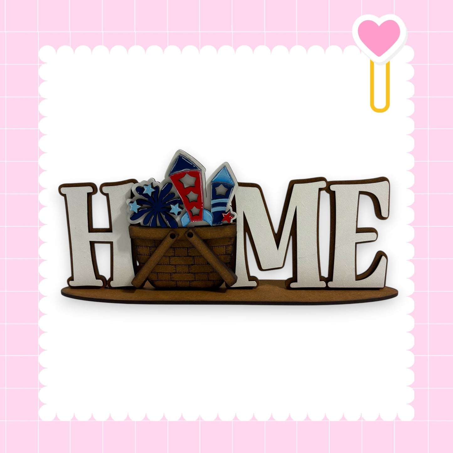 A wooden sign with the word "HOME" in large letters, with a basket filled with colorful fireworks placed underneath it.