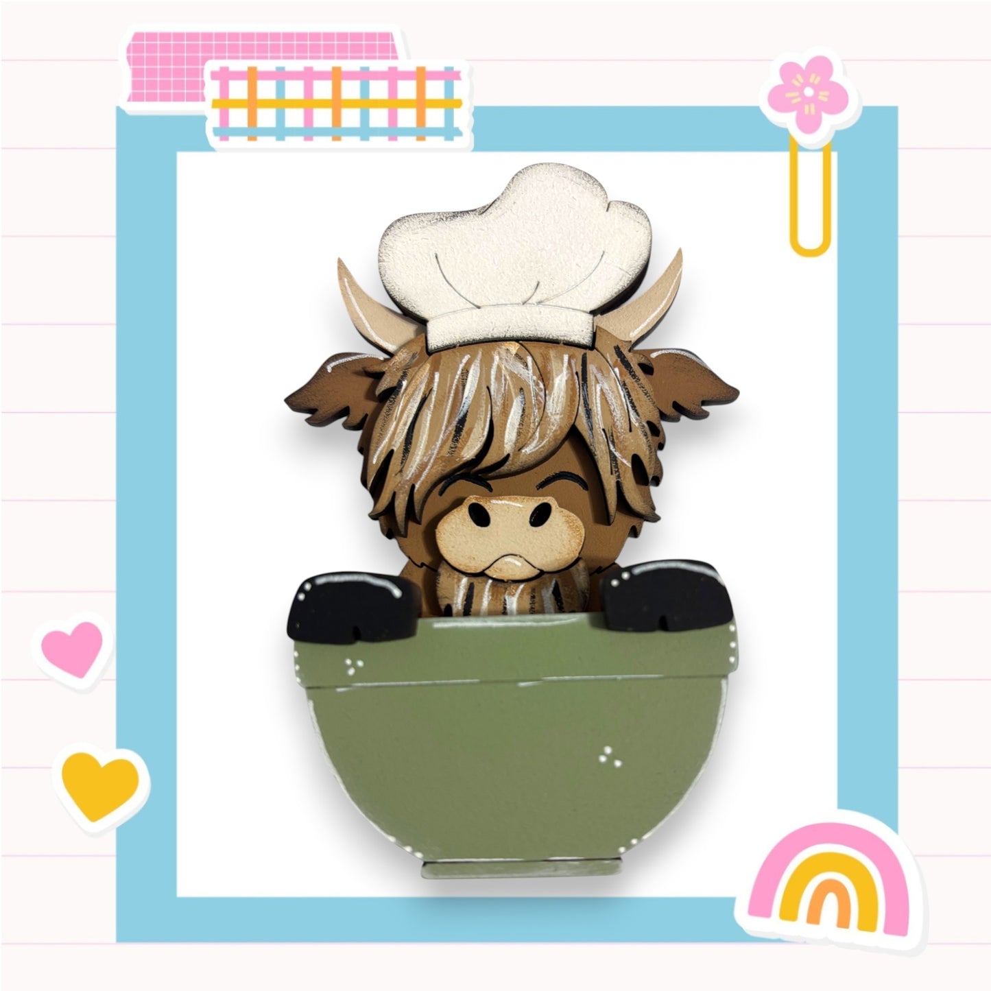 A cartoon cow wearing a chef's hat is sitting in a green bowl, surrounded by various colorful and whimsical elements such as hearts, a rainbow, and a flower.