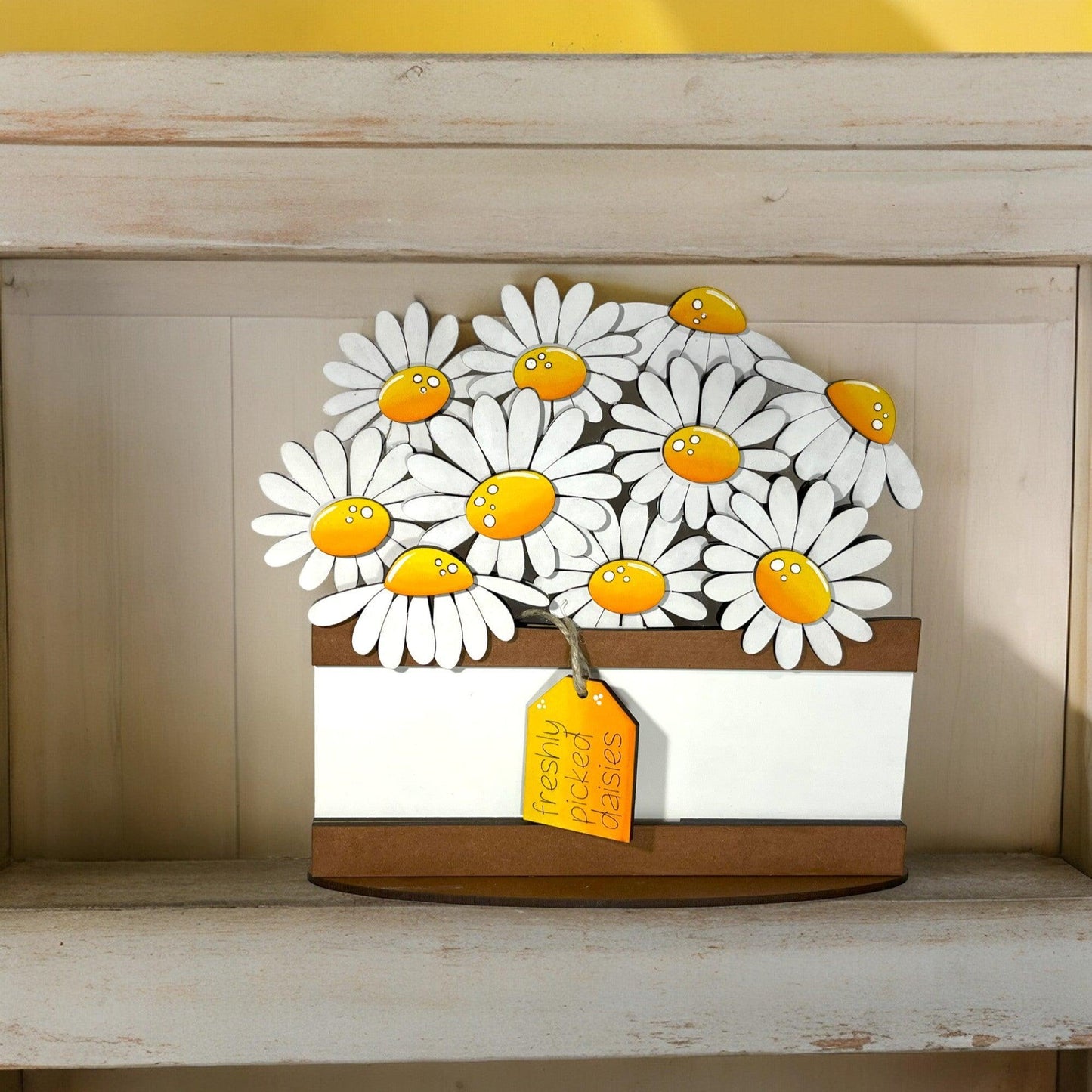 a picture of a bunch of daisies on a shelf