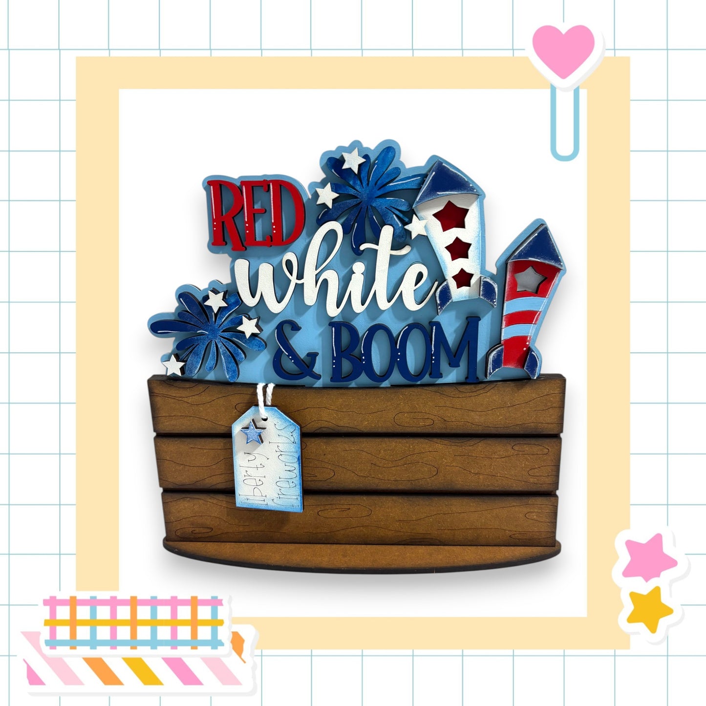 a wooden basket with the words "RED white & BOOM" written on it, surrounded by various colorful and festive elements such as stars, hearts, and fireworks.