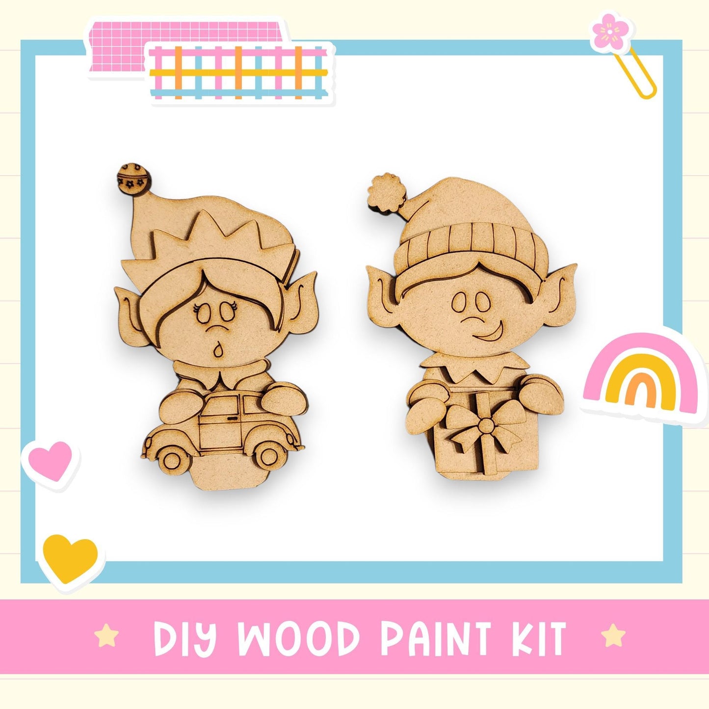 two wooden elf figurines, one standing and one sitting, along with a DIY wood paint kit and various decorative elements such as hearts and a rainbow.