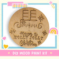 a DIY wood paint kit for creating a wooden ornament with a Christmas message.