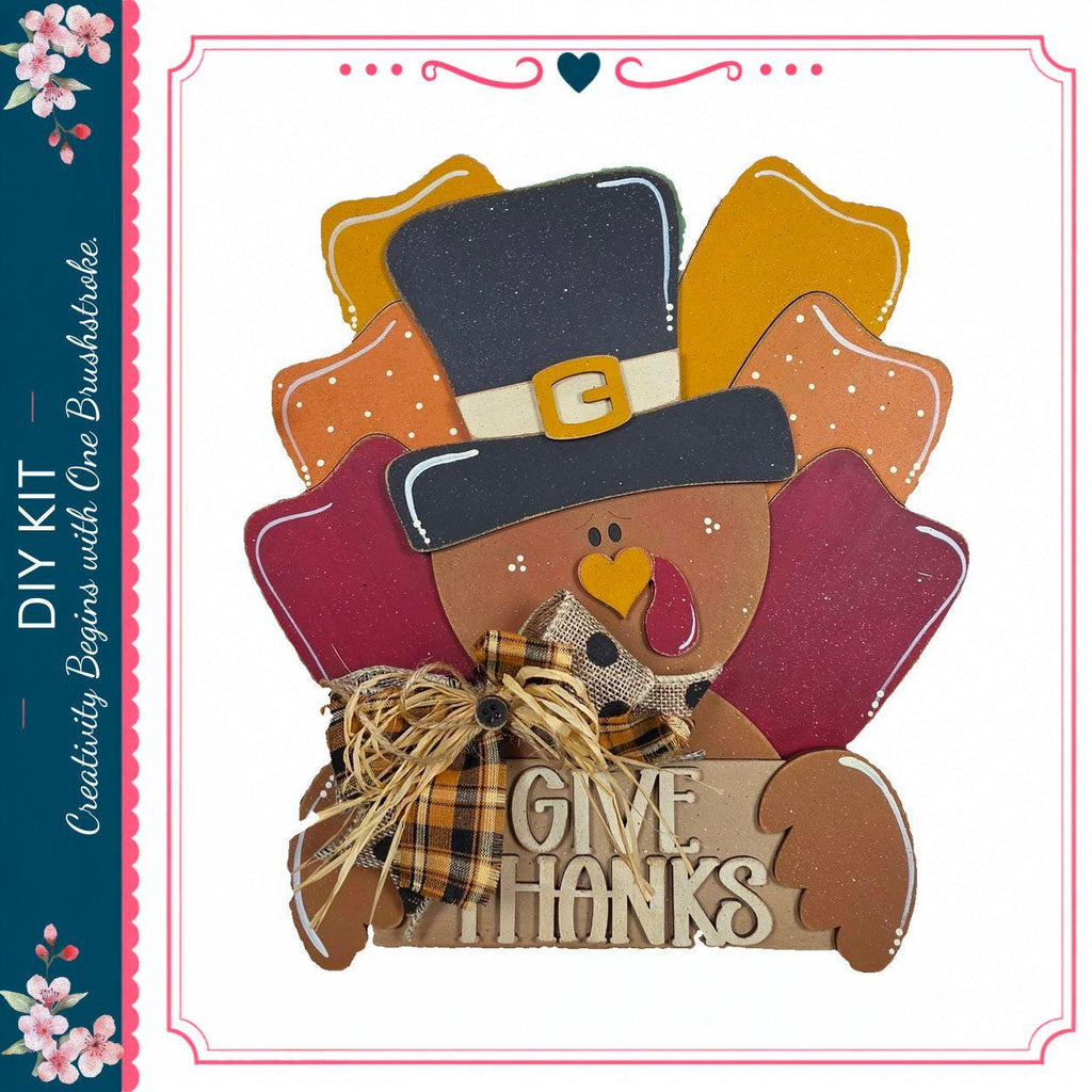 A wooden turkey decoration with a hat and the text "Give Thanks" is displayed against a white background.