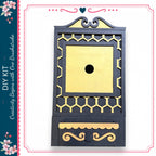 a decorative black and gold box with a gold-colored hole in the center.