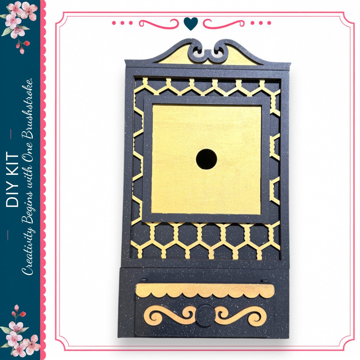 a decorative black and gold box with a gold-colored hole in the center.