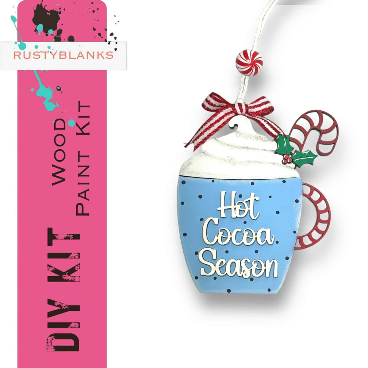 a hot cocoa season ornament hanging from a pink ribbon