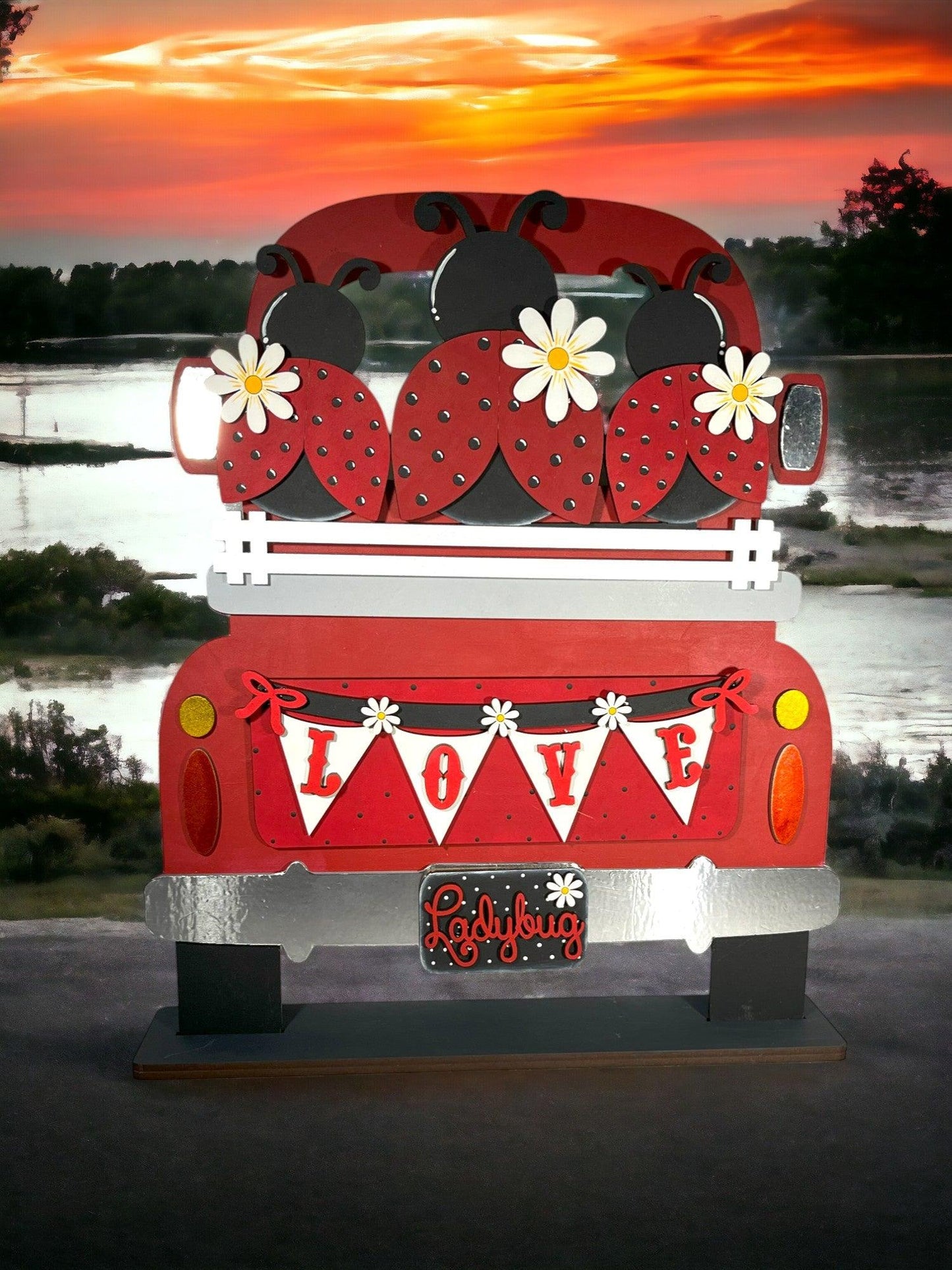 a red truck with a ladybug decoration on the back of it