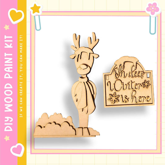 a wooden deer figurine and a wooden sign with the text "Oh, winter is here".