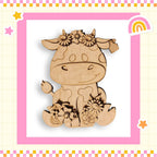 a wooden cutout of a cow with flowers