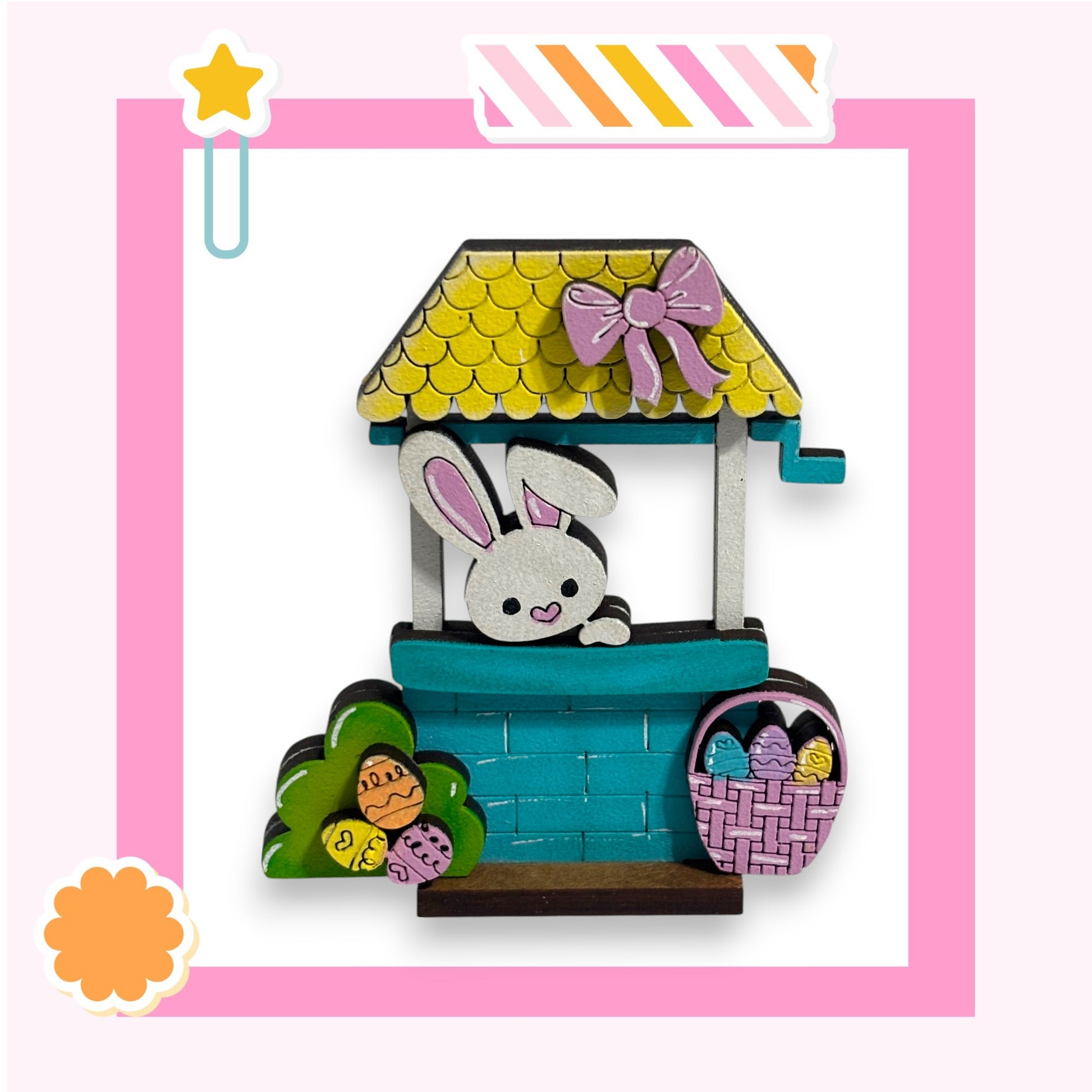A wooden toy house with a bunny inside, decorated for Easter.