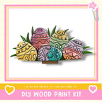 A DIY wood paint kit featuring colorful Easter eggs with intricate designs, displayed on a white background within a pink and yellow frame.