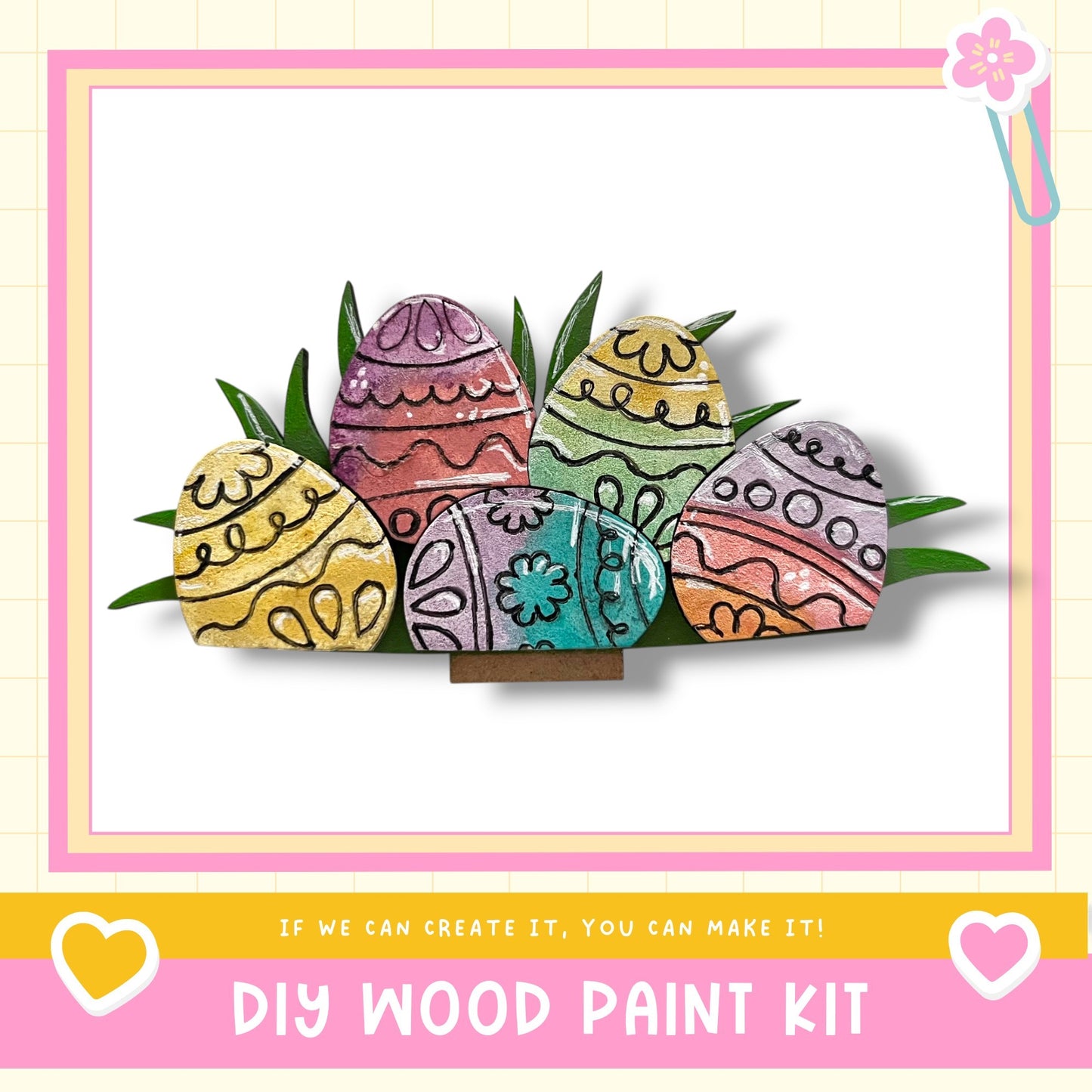 A DIY wood paint kit featuring colorful Easter eggs with intricate designs, displayed on a white background within a pink and yellow frame.