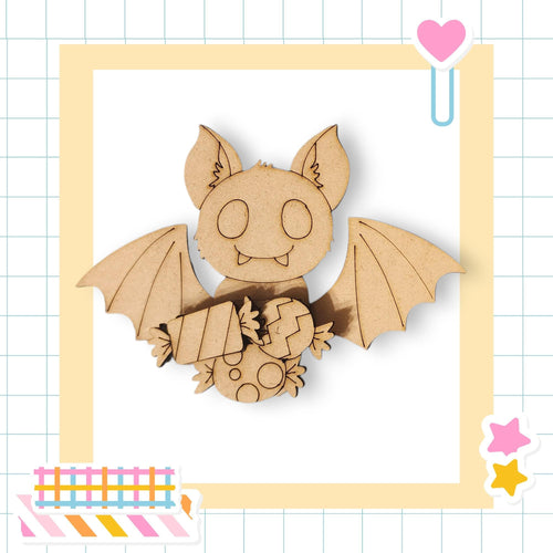 A wooden bat-shaped figure holding a candy-filled heart, set against a yellow and white grid background with a pink heart and a pink star sticker.