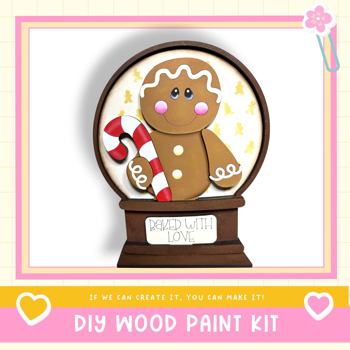 A gingerbread man figure holding a candy cane, with the text "BAKED WITH LOVE" on a wooden base, and the text "DIY WOOD PAINT KIT" below.