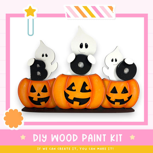a DIY wood paint kit for creating Halloween decorations, including carved pumpkins and ghost figures.