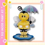 A cheerful yellow bee holding an umbrella and wearing rain boots stands on a puddle, surrounded by a pink and yellow border with hearts and stars.