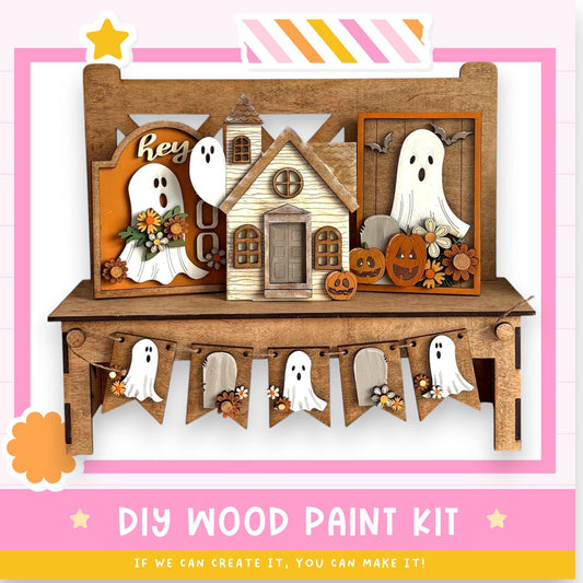 The image is a DIY wood paint kit for creating Halloween decorations, including a wooden house, ghost figures, and a banner with ghostly figures.