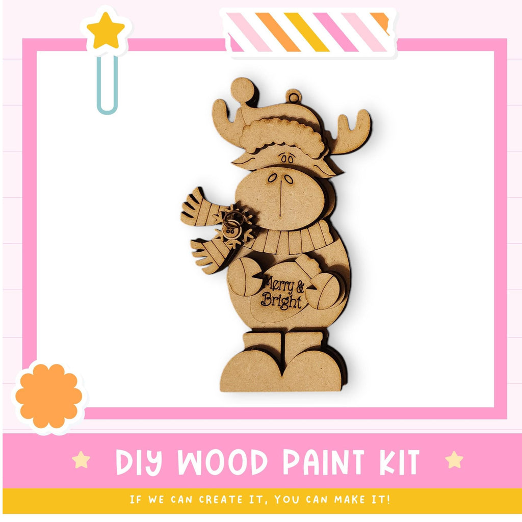 a DIY wood paint kit for creating a wooden ornament, with a cute wooden snowman figure as the main subject.