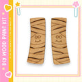 two wooden slats with a smiling face design on them, set against a pink and yellow background with decorative elements.