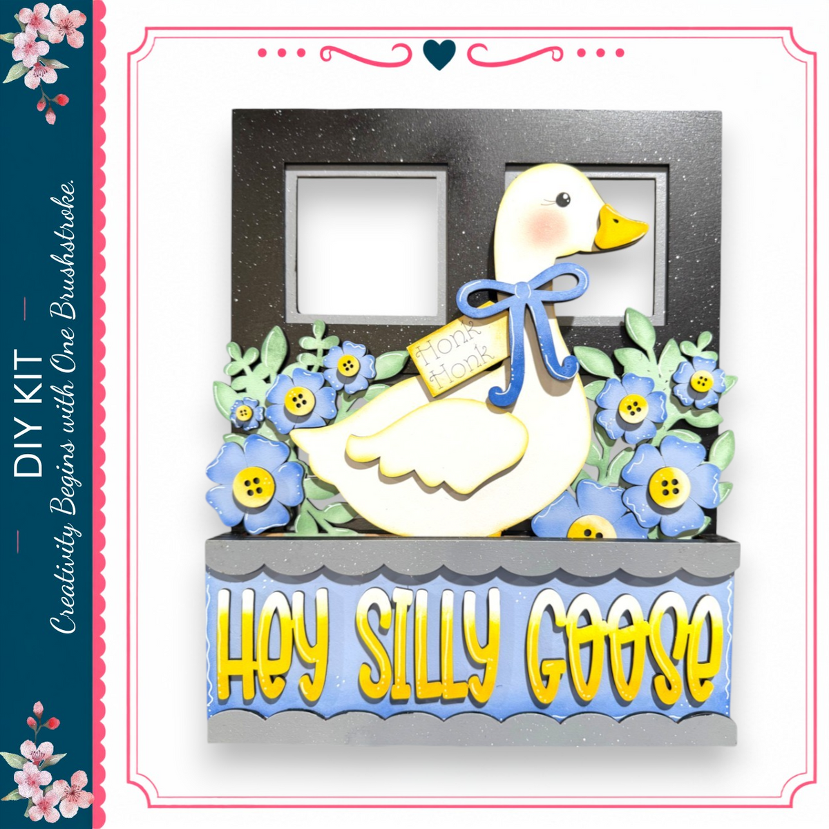 a decorative frame with a cartoon duck wearing a blue bow and surrounded by blue flowers. The frame has two empty spaces on either side of the duck, and the phrase "Hey Silly Goose" is written on the frame.