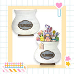 two white vases filled with flowers on top of a table