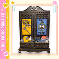 The image is a wooden paint kit featuring a decorative cabinet with various items and text.