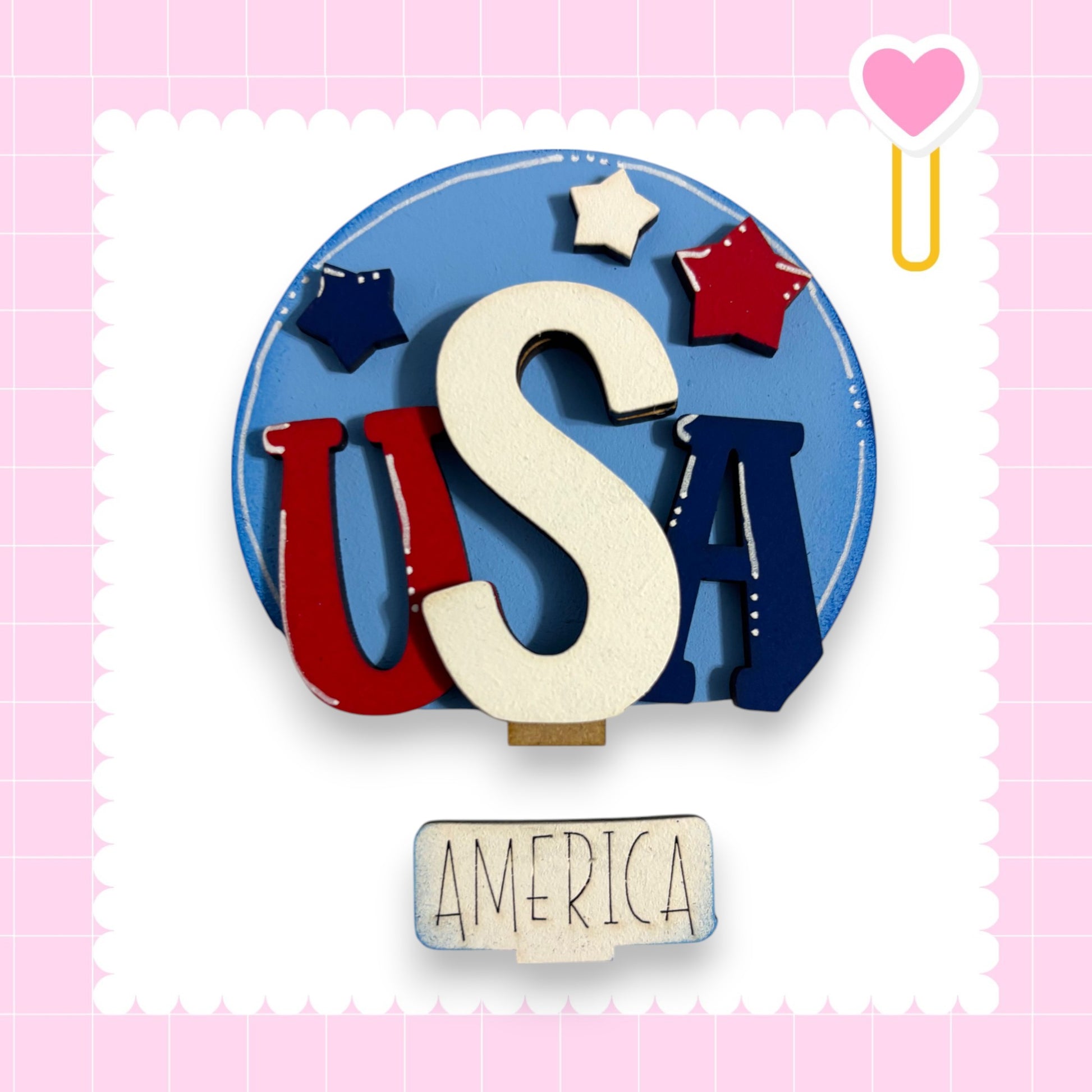 a circular arrangement of the letters 'USA' in red, white, and blue, with a heart-shaped object and stars on the edges. Below the arrangement, the word "AMERICA" is written.