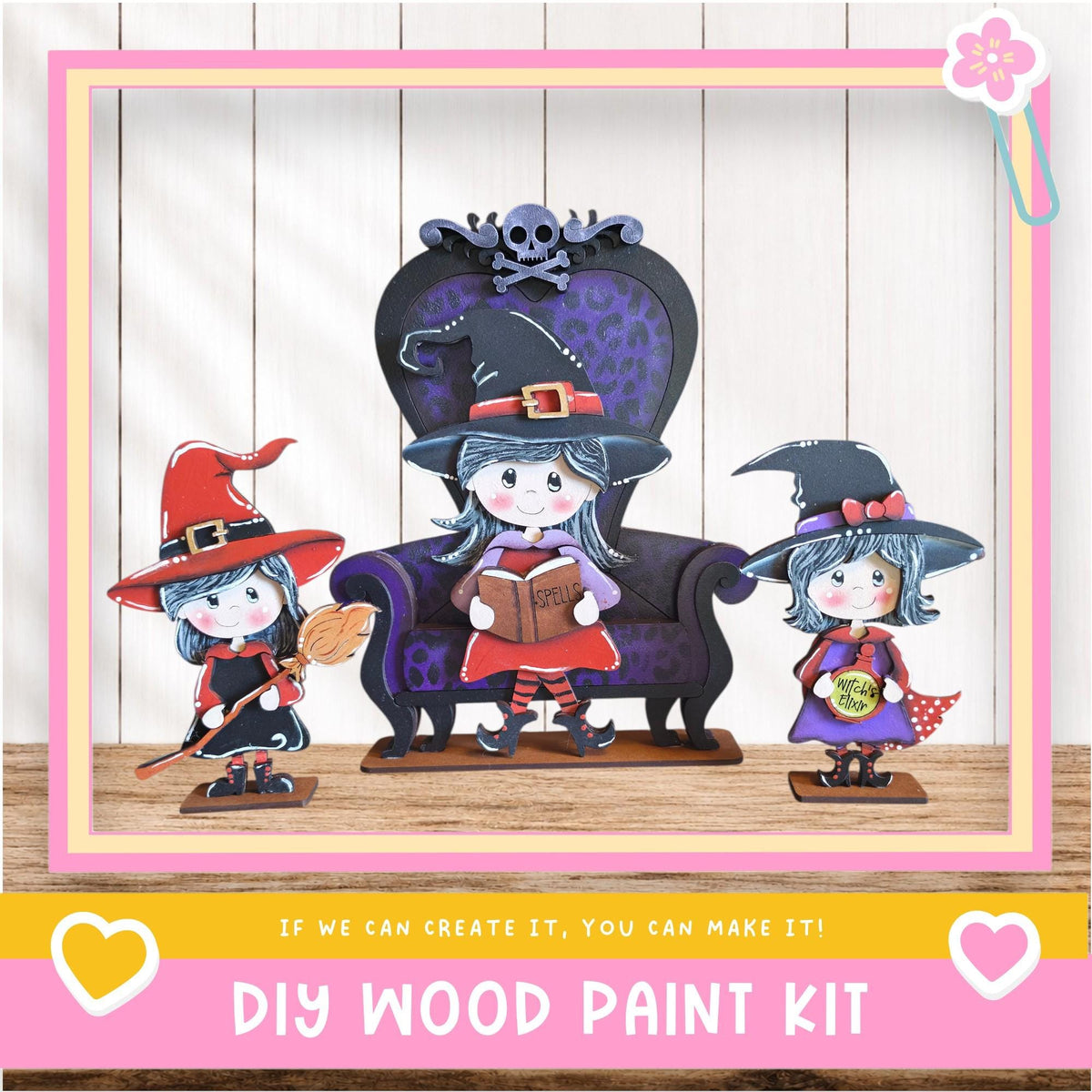 A DIY wood paint kit featuring three wooden dolls dressed as witches, with one doll sitting on a chair and the other two standing on the floor.
