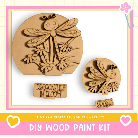 a DIY wood paint kit, including a dragonfly-shaped cutout and a spring-themed cutout, both made of wood. The kit is designed for creating custom wooden designs, such as the dragonfly and spring motifs.