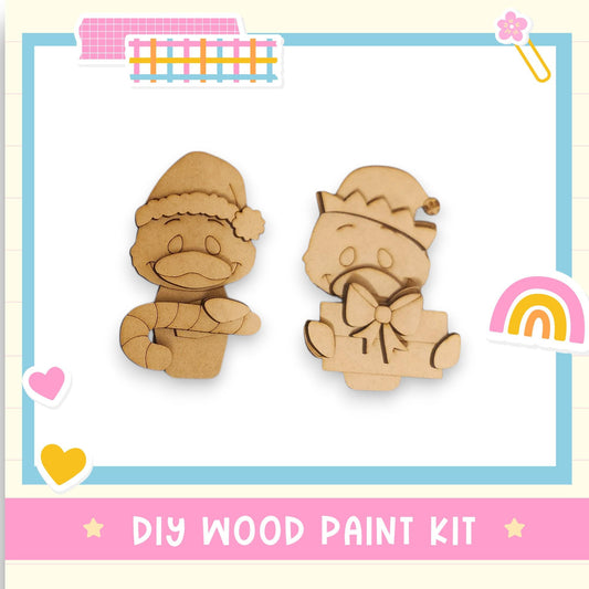 two wooden toys, one resembling a duck and the other a cat, along with various decorative elements such as a rainbow, hearts, and a pink and blue border. The image also includes the text "DIY WOOD PAINT KIT" and "DIY WOOD PAINT KIT" in the lower right corner.