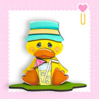 a yellow duck with a blue hat and a drink