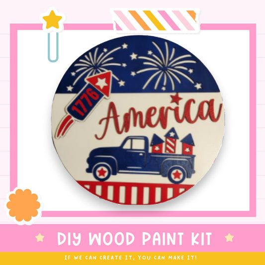 The image is a promotional poster for a DIY wood paint kit, featuring a patriotic design with a truck, fireworks, and the word "America" written on it.