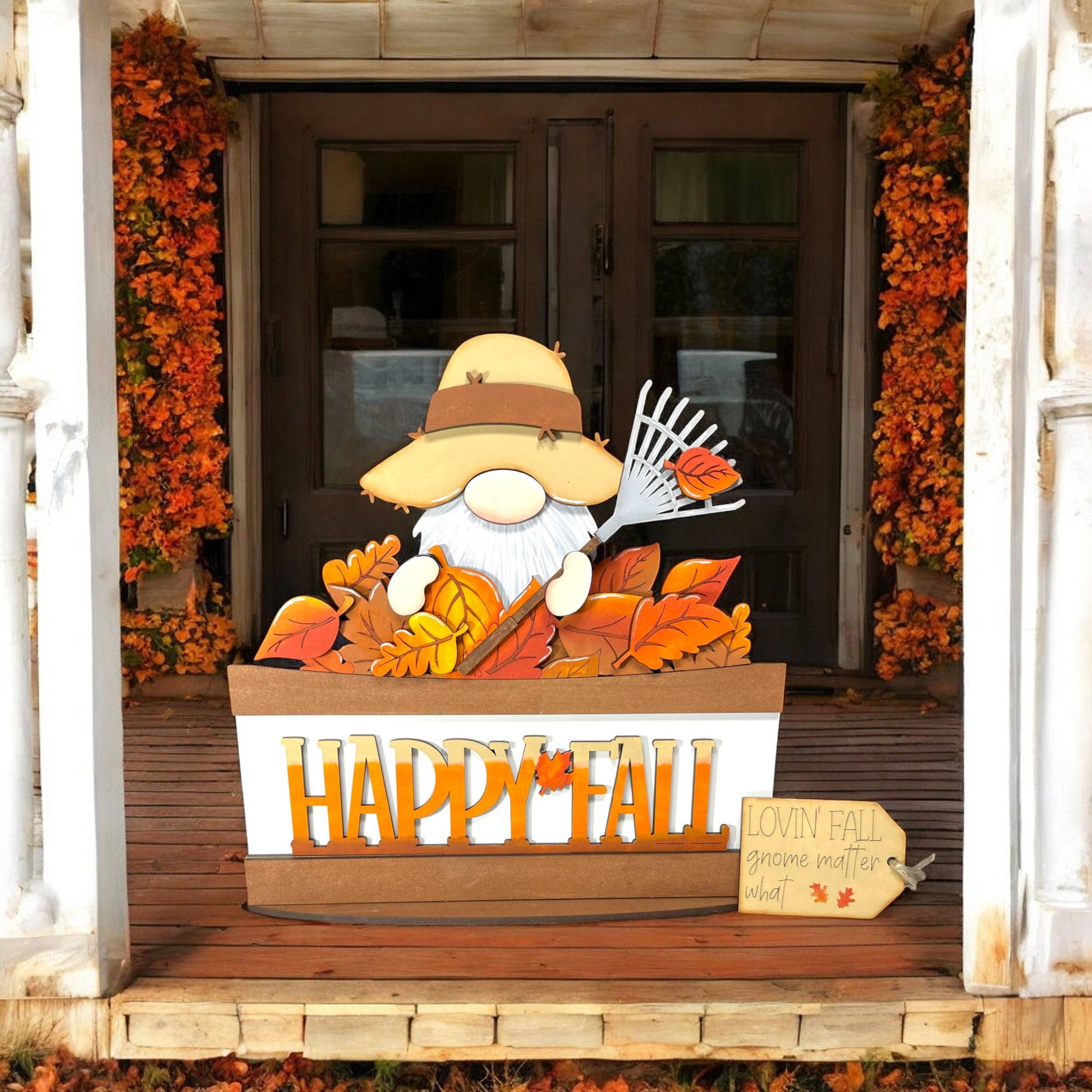 a wooden sign that says happy fall on a porch