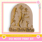 a DIY wood paint kit for creating a wooden snow globe with a bear and snowflakes.
