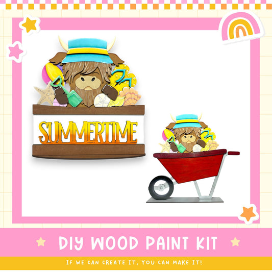 The image is a colorful and playful DIY wood paint kit featuring a cartoon character wearing a hat and holding various objects, such as a red wheelbarrow and a yellow shovel. The kit appears to be designed for children to create their own wooden artwork.