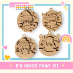 a DIY wood paint kit with four wooden ornaments, each depicting a different animal, including a moose, a unicorn, a bear, and a rabbit.