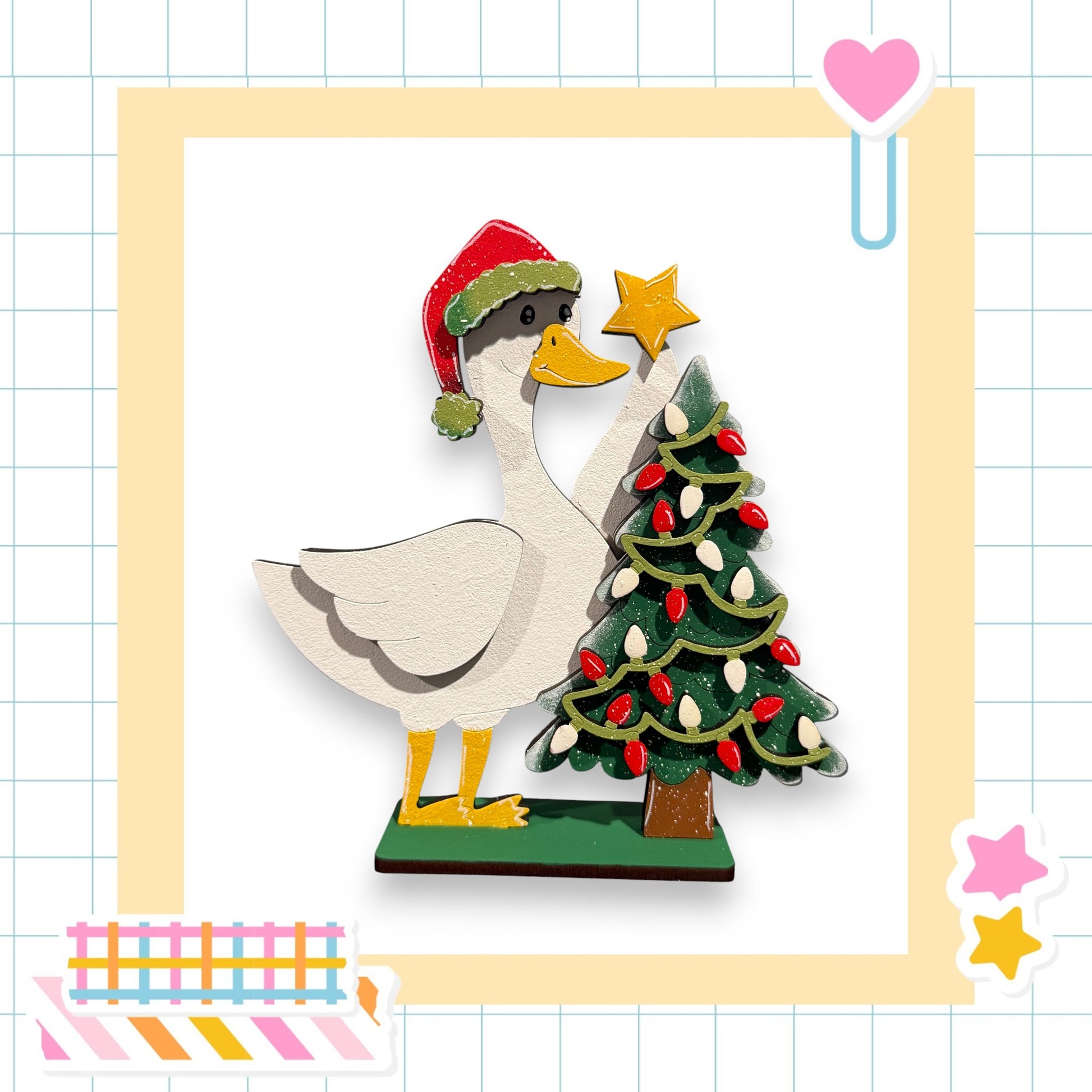 A wooden duck wearing a Santa hat is decorating a Christmas tree with lights and a star.