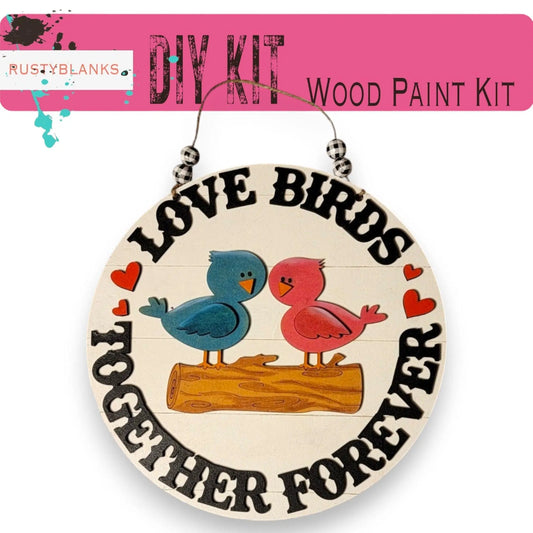 a pair of birds sitting on top of a wooden sign